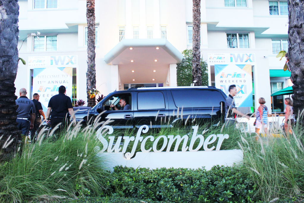 The entrance to the Surfcomber hotel with its sign in the garden, guests arriving
