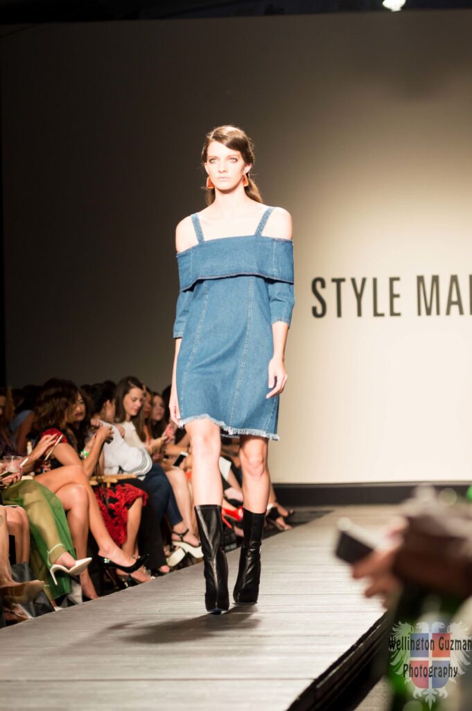 A model in a cold-shoulder denim dress on the Style Mafia runway