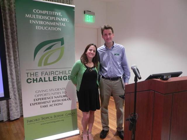 Amy Padolf and Dr. Carl Lewis standing beside a Fairchild Challenge banner