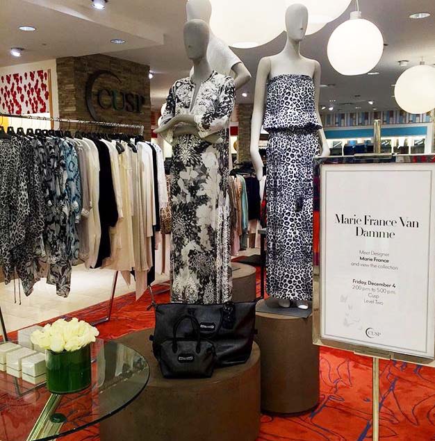 Mannequins in black-and-white printed clothes in a store, a sign for Marie France Van Damme