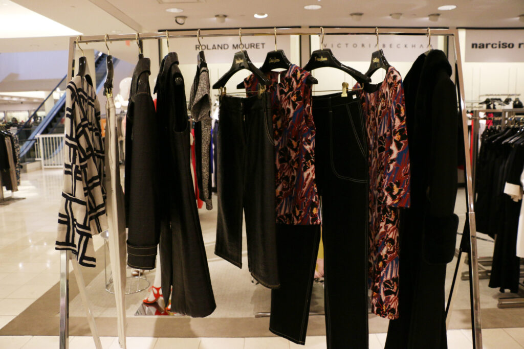 A rail of black, patterned and red clothes in a department store