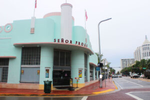 The pale green Art Deco building of Señor Frog's on a Miami Beach street corner