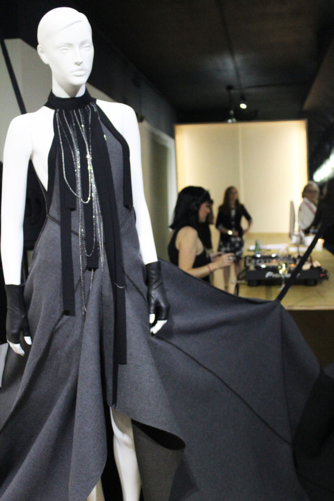 A mannequin in a long draped black gown in a boutique