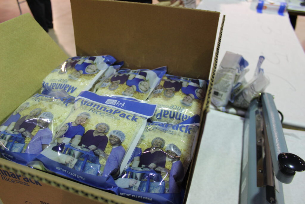 A cardboard box full of sealed MannaPack meal bags