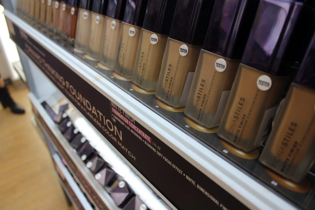 A row of foundation bottles in different shades on a store shelf