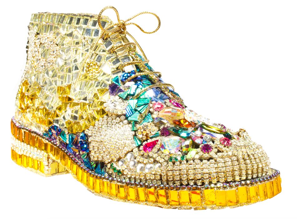 A lace-up boot sculpture covered in gold, crystals and colourful stones