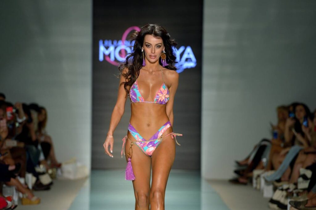 A model in a purple printed bikini on the runway at a Liliana Montoya show