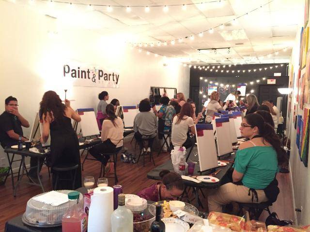 A room full of people painting at easels at a Paint Party