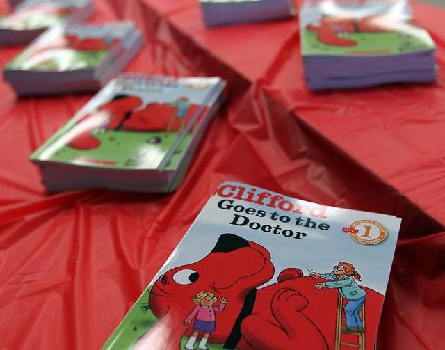 Clifford Goes to the Doctor books laid out on a red tablecloth