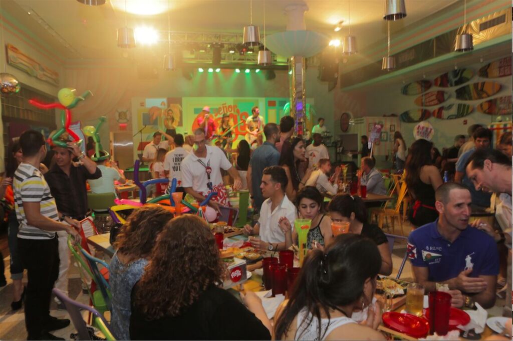 A packed, colourful restaurant full of diners and balloons