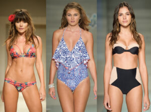 Three models side by side in a floral bikini, a blue-and-white ruffled swimsuit and a black-and-nude swimsuit