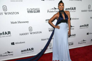 Gabrielle Union in a pale blue gown with a dark velvet sash on the amfAR red carpet