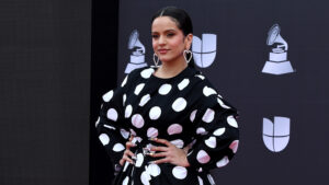 Rosalía in a black-and-white polka-dot dress with puffed sleeves on the Latin Grammys red carpet