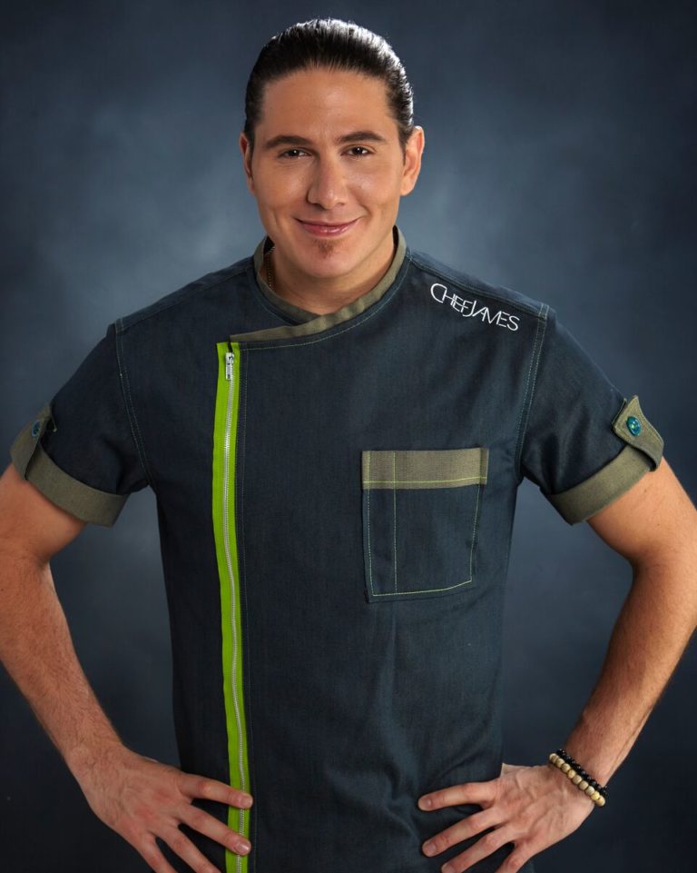 Chef James in a dark chef's jacket with a green stripe, hands on hips