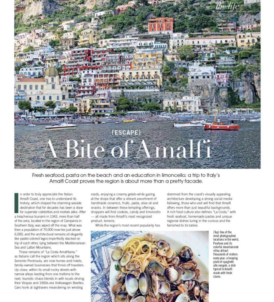 An Indulge magazine page headed "A Bite of Amalfi", with a coastal town photo and a plate of clams